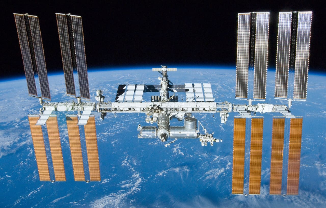 The International Space Station photographed against the black of space with its solar arrays extended